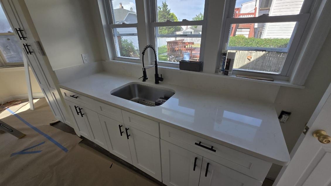 Quartz counters, matte-black pulls — A&J Cabinet Studio install